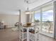 Bright dining area features table for four with a view of the pool and ocean at 601 Retreat Beach Circle # 215, Pawleys Island, SC 29585