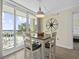 Bright dining area features table for four with a view of the pool and ocean at 601 Retreat Beach Circle # 215, Pawleys Island, SC 29585