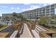 Multi-story condominium building with private balconies, lush landscaping and a convenient boardwalk at 601 Retreat Beach Circle # 215, Pawleys Island, SC 29585