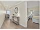 Hallway leading to bedroom with two beds offers a glimpse of the living space and ocean view at 601 Retreat Beach Circle # 215, Pawleys Island, SC 29585