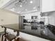 Modern kitchen featuring stainless steel appliances, granite counters, and white cabinetry at 601 Retreat Beach Circle # 215, Pawleys Island, SC 29585
