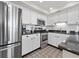 Modern kitchen featuring stainless steel appliances, granite counters, and white cabinetry at 601 Retreat Beach Circle # 215, Pawleys Island, SC 29585