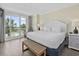 Bright main bedroom with a king bed, balcony access and coastal decor at 601 Retreat Beach Circle # 215, Pawleys Island, SC 29585