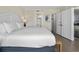 Bright main bedroom featuring a king bed, nightstands, and access to ensuite bathroom at 601 Retreat Beach Circle # 215, Pawleys Island, SC 29585