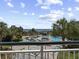 Beautiful pool and ocean view from a balcony, with palm trees and lounge chairs visible at 601 Retreat Beach Circle # 215, Pawleys Island, SC 29585