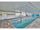 Indoor pool area featuring a brick surround, ample seating, and tiled ceiling detail at 601 Retreat Beach Circle # 215, Pawleys Island, SC 29585