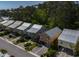 Aerial view showcases a row of beach homes, each with unique colors and landscaping at 93 Weatherboard Ct., Pawleys Island, SC 29585