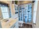 Well-lit bathroom featuring a vanity, toilet, and charming beach-themed shower curtain at 93 Weatherboard Ct., Pawleys Island, SC 29585