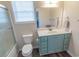 Bright bathroom features a tub with shower, toilet, and vanity with blue cabinets at 93 Weatherboard Ct., Pawleys Island, SC 29585
