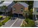 View of the beach home with colorful exterior, landscaping, and covered parking at 93 Weatherboard Ct., Pawleys Island, SC 29585