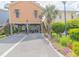 Inviting raised beach home featuring well manicured landscaping and an extended driveway at 93 Weatherboard Ct., Pawleys Island, SC 29585