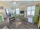 Bright living room featuring a ceiling fan, hardwood floors, beach-themed decor, and a comfortable seating area at 93 Weatherboard Ct., Pawleys Island, SC 29585