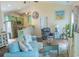 Open living room with vaulted ceilings, stainless appliances, and beach-themed decor provides an airy and inviting atmosphere at 93 Weatherboard Ct., Pawleys Island, SC 29585