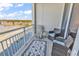 Relax on this peaceful balcony with waterfront views and comfortable wicker furniture at 9547 Edgerton Dr. # 702, Myrtle Beach, SC 29572