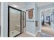Bright bathroom featuring a glass-enclosed shower with a built-in seat and beige tile at 9547 Edgerton Dr. # 702, Myrtle Beach, SC 29572