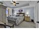Tranquil bedroom with tray ceiling, balcony access, and sophisticated decor at 9547 Edgerton Dr. # 702, Myrtle Beach, SC 29572
