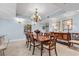 Elegant dining room with a chandelier, custom wood table set, and buffet at 9547 Edgerton Dr. # 702, Myrtle Beach, SC 29572