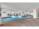Inviting indoor pool area with lounge chairs and large windows at 9547 Edgerton Dr. # 702, Myrtle Beach, SC 29572