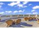 Expansive rooftop deck with comfortable wicker seating, offering stunning ocean views at 9547 Edgerton Dr. # 702, Myrtle Beach, SC 29572