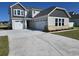Charming two-story home with a three-car garage and manicured front lawn on a sunny day at 1004 Gold Dew Way, Myrtle Beach, SC 29579