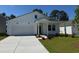 Charming, newly constructed two-story white home with a well-manicured lawn and attached garage at 1027 Laconic Dr., Myrtle Beach, SC 29588