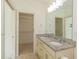 Bathroom showcasing a double vanity, granite countertop, and walk-in closet access at 105 Villa Mar Dr. # C-1, Myrtle Beach, SC 29579