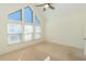 Bright bedroom featuring large windows, vaulted ceiling, and a modern ceiling fan at 105 Villa Mar Dr. # C-1, Myrtle Beach, SC 29579