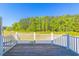 Inviting deck with white railings overlooking scenic tree-lined landscape at 105 Villa Mar Dr. # C-1, Myrtle Beach, SC 29579