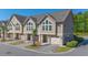 Street view of a townhome featuring a two-car garage, palm tree, and manicured lawn at 105 Villa Mar Dr. # C-1, Myrtle Beach, SC 29579