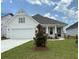 Charming single-story home with a two-car garage, well-manicured lawn, and inviting front entrance at 1051 Laconic Dr., Myrtle Beach, SC 29588