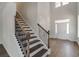 Bright foyer featuring wood-look floors, stairway with dark wood steps and iron railing, and a front door with sidelights at 1056 Laconic Dr., Myrtle Beach, SC 29588