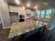 Gourmet kitchen showcasing granite countertops, large island, stainless steel appliances, and stylish pendant lighting at 1056 Laconic Dr., Myrtle Beach, SC 29588