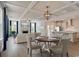 Open-concept living room with coffered ceilings seamlessly connects the dining and kitchen areas at 1056 Laconic Dr., Myrtle Beach, SC 29588