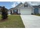 Charming single-story home with gray siding, landscaped yard, and a two-car garage at 1059 Laconic Dr., Myrtle Beach, SC 29588