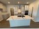 Modern kitchen featuring a large island with quartz countertops, stainless steel appliances, and white cabinets at 1059 Laconic Dr., Myrtle Beach, SC 29588