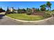 Neighborhood entrance featuring a green space, signage, flowers, and the Waterbridge name at 1232 Needle Grass Loop, Myrtle Beach, SC 29579