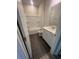 Well-lit bathroom featuring a shower-tub combo, dark tile flooring, and vanity with sink at 1237 Lady Bird Way, North Myrtle Beach, SC 29582