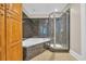 Granite-walled bathroom showcases a modern shower and a luxurious soaking tub, complemented by wooden cabinets for storage at 1313 Villa Marbella Ct. # 4-102, Myrtle Beach, SC 29572