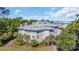 Aerial view of condo complex featuring manicured lawns and mature landscaping with palm trees at 1313 Villa Marbella Ct. # 4-102, Myrtle Beach, SC 29572