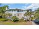Exterior elevation of Villa Marbella condo complex with manicured lawns and palm trees at 1313 Villa Marbella Ct. # 4-102, Myrtle Beach, SC 29572