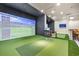 An indoor golf simulator room with putting green and modern equipment at 1313 Villa Marbella Ct. # 4-102, Myrtle Beach, SC 29572