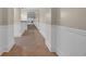 Hallway featuring tile floors, wainscoting, and views to the exterior at 1313 Villa Marbella Ct. # 4-102, Myrtle Beach, SC 29572