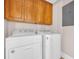 Practical laundry room with washer and dryer, complete with overhead cabinets for convenient storage and organization at 1313 Villa Marbella Ct. # 4-102, Myrtle Beach, SC 29572