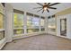 Bright sunroom features tiled flooring, a ceiling fan, and expansive windows that provide abundant light and exterior views at 1313 Villa Marbella Ct. # 4-102, Myrtle Beach, SC 29572
