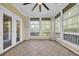 Inviting sunroom with tiled floors, a ceiling fan, and large windows offering serene outdoor views and natural light at 1313 Villa Marbella Ct. # 4-102, Myrtle Beach, SC 29572