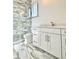 Modern bathroom showcasing marble tile shower with glass door and white vanity with marble countertop at 133 Serenity Point Dr., Little River, SC 29566