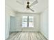 Bright bedroom with hardwood floors, a ceiling fan, and large windows providing natural light at 133 Serenity Point Dr., Little River, SC 29566