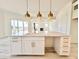 A kitchen island boasts gold hardware and a stone countertop at 133 Serenity Point Dr., Little River, SC 29566