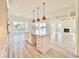 A kitchen island with gold pendant lights, quartz countertop, and lake views at 133 Serenity Point Dr., Little River, SC 29566