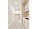 Modern laundry room with white cabinets, marble countertops, and elegant patterned floor tiles at 133 Serenity Point Dr., Little River, SC 29566